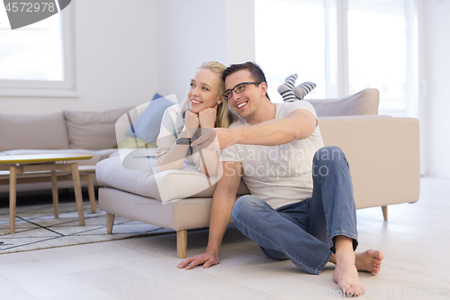 Image of Young couple on the sofa watching television