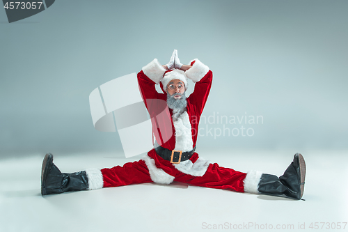 Image of Funny guy in christmas hat. New Year Holiday. Christmas, x-mas, winter, gifts concept.