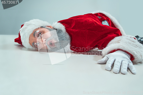 Image of red white santa claus overworked frustration burnout concept lying on floor isolated on white background