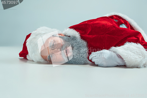 Image of red white santa claus overworked frustration burnout concept lying on floor isolated on white background