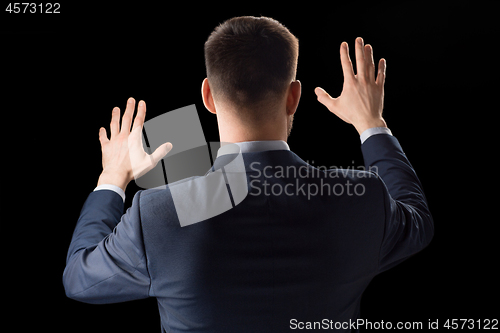 Image of businessman working with invisible virtual screen