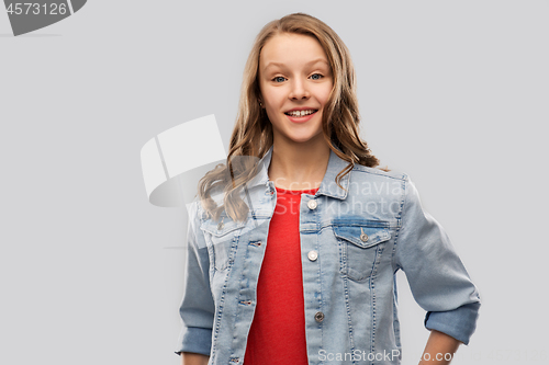 Image of smiling teenage girl in denim jacket