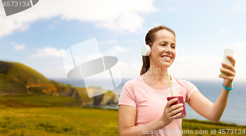 Image of woman with smartphone and shake listening to music