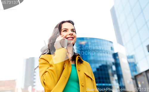 Image of smiling young woman or girl calling on smartphone