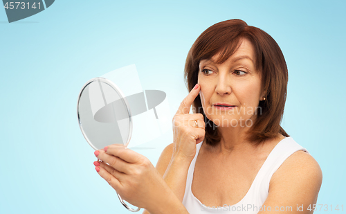 Image of portrait of smiling senior woman with mirror