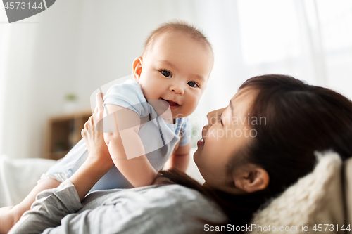 Image of happy mother with little baby son at home