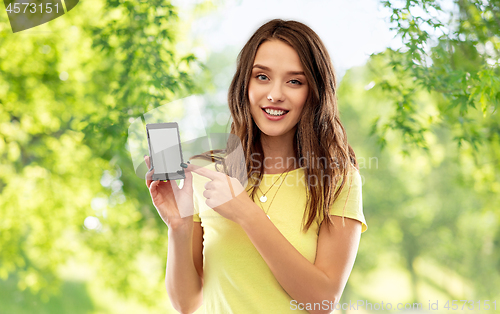 Image of young woman or teenage girl holding smartphone