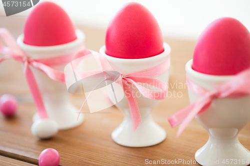 Image of easter eggs in holders and candy drops on table
