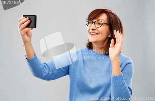 Image of senior woman having video call on smartphone