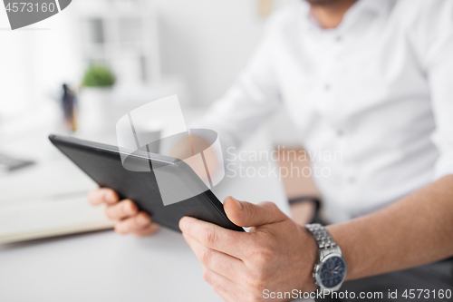 Image of close up of businessman with tablet pc at office