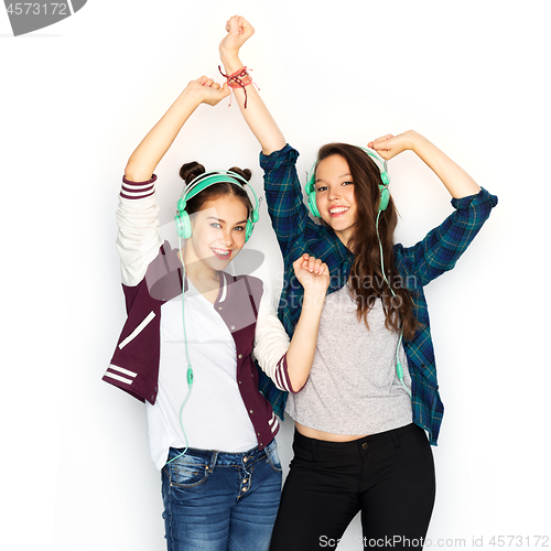 Image of teenage girls in earphones listening to music