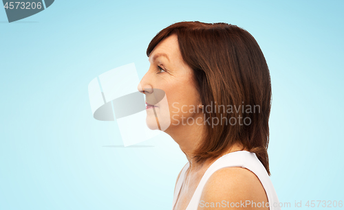 Image of profile of senior woman over white background