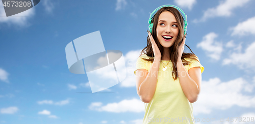 Image of happy young woman or teenage girl with headphones