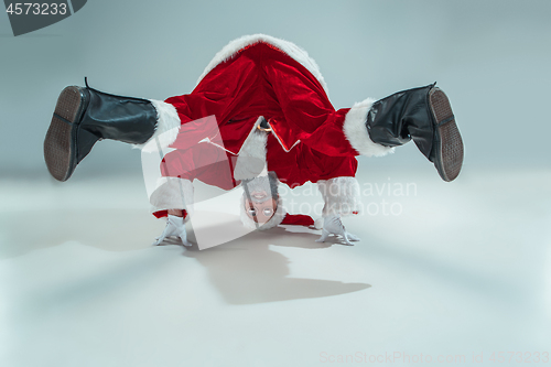 Image of Funny guy in christmas hat. New Year Holiday. Christmas, x-mas, winter, gifts concept.