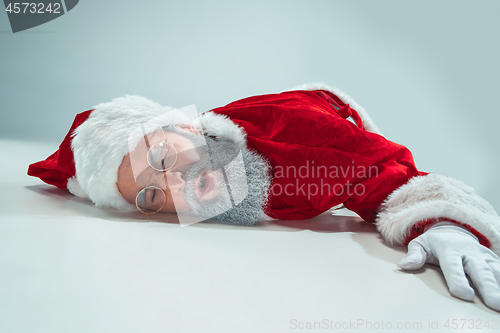 Image of red white santa claus overworked frustration burnout concept lying on floor isolated on white background