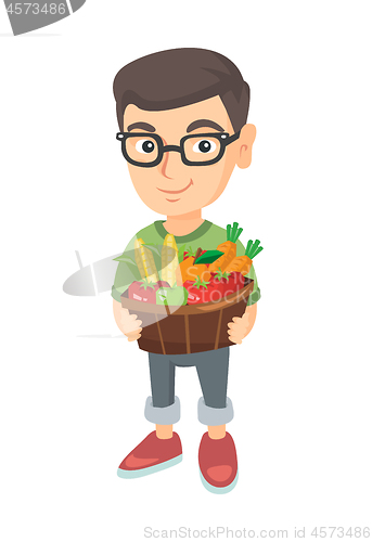 Image of Boy holding basket with fruit and vegetables.