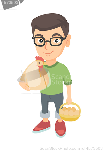 Image of Caucasian boy holding a chicken and hen eggs.