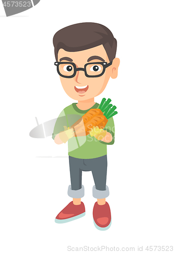 Image of Caucasian boy in glasses holding fresh carrot.