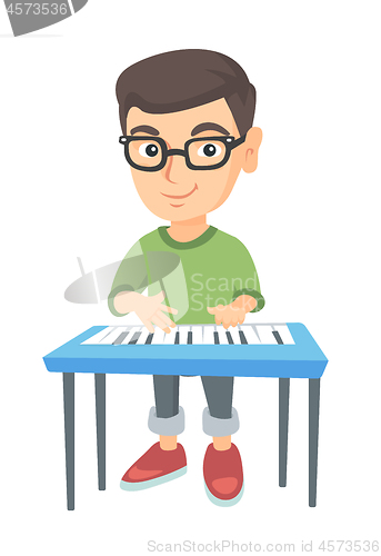 Image of Little caucasian boy playing the piano.