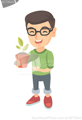 Image of Caucasian smiling boy holding a potted plant.