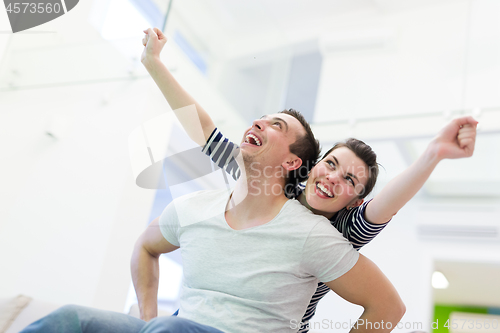 Image of handsome man piggybacking his girlfriend