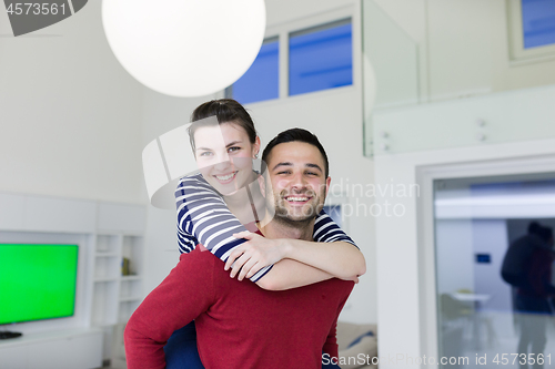 Image of handsome man piggybacking his girlfriend