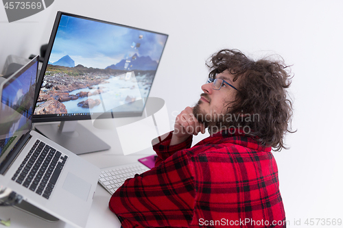 Image of graphic designer in bathrobe working at home