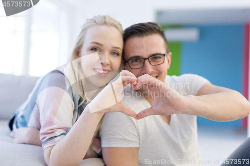 Image of couple making heart with hands