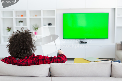 Image of young man in bathrobe enjoying free time