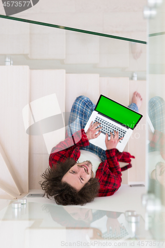 Image of freelancer in bathrobe working from home