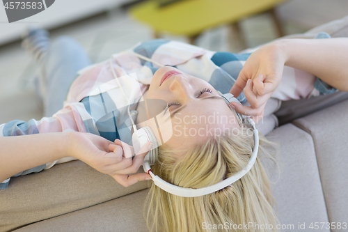 Image of girl enjoying music through headphones