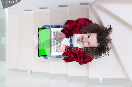 Image of freelancer in bathrobe working from home