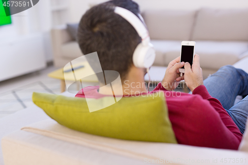 Image of man enjoying music through headphones
