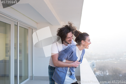 Image of Couple hugging on the balcony