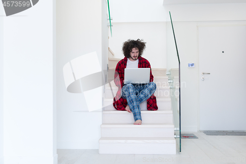 Image of freelancer in bathrobe working from home