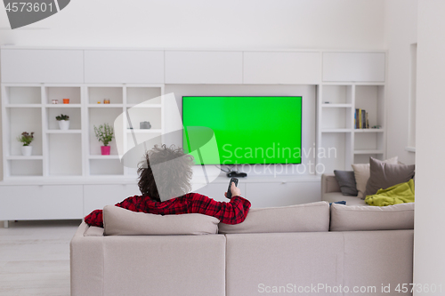 Image of young man in bathrobe enjoying free time