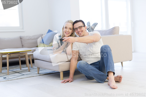 Image of Young couple on the sofa watching television