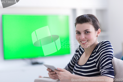 Image of woman on sofa using tablet computer