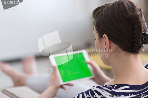 Image of woman on sofa using tablet computer