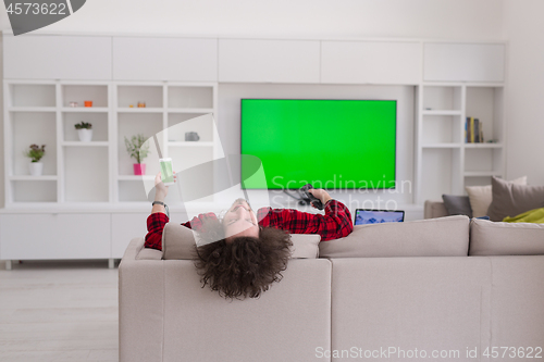 Image of young man in bathrobe enjoying free time