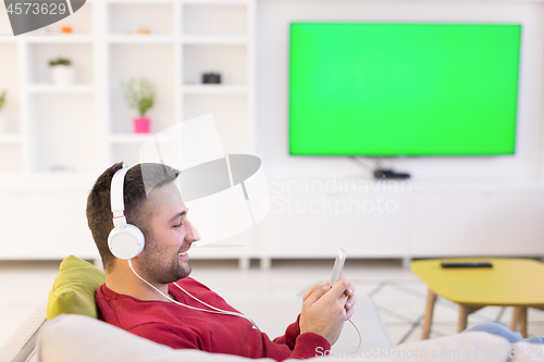 Image of man enjoying music through headphones