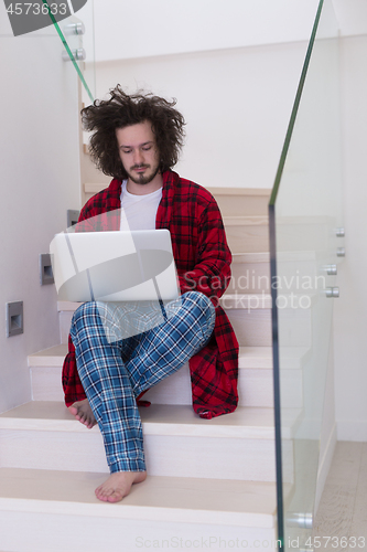 Image of freelancer in bathrobe working from home