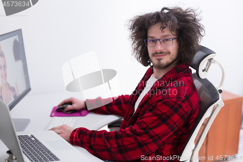 Image of graphic designer in bathrobe working at home