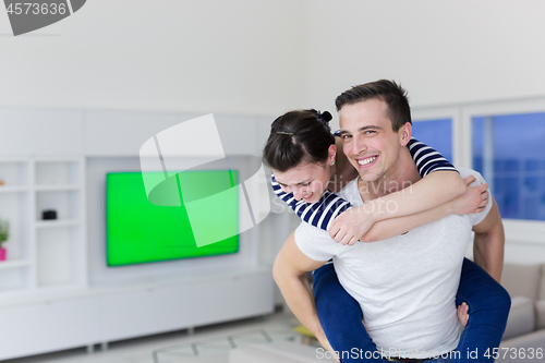 Image of handsome man piggybacking his girlfriend