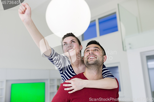 Image of handsome man piggybacking his girlfriend