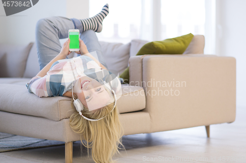 Image of girl enjoying music through headphones