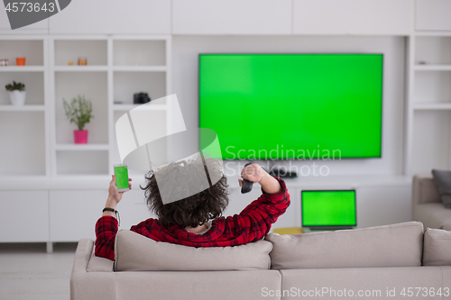 Image of young man in bathrobe enjoying free time