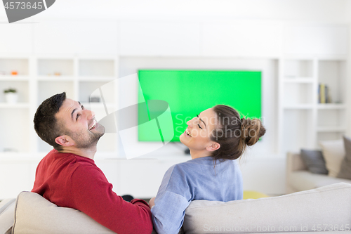 Image of Young couple on the sofa watching television