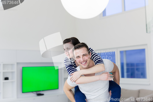 Image of handsome man piggybacking his girlfriend