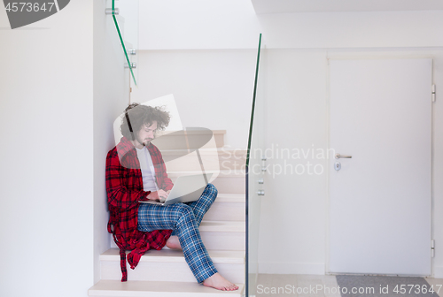 Image of freelancer in bathrobe working from home